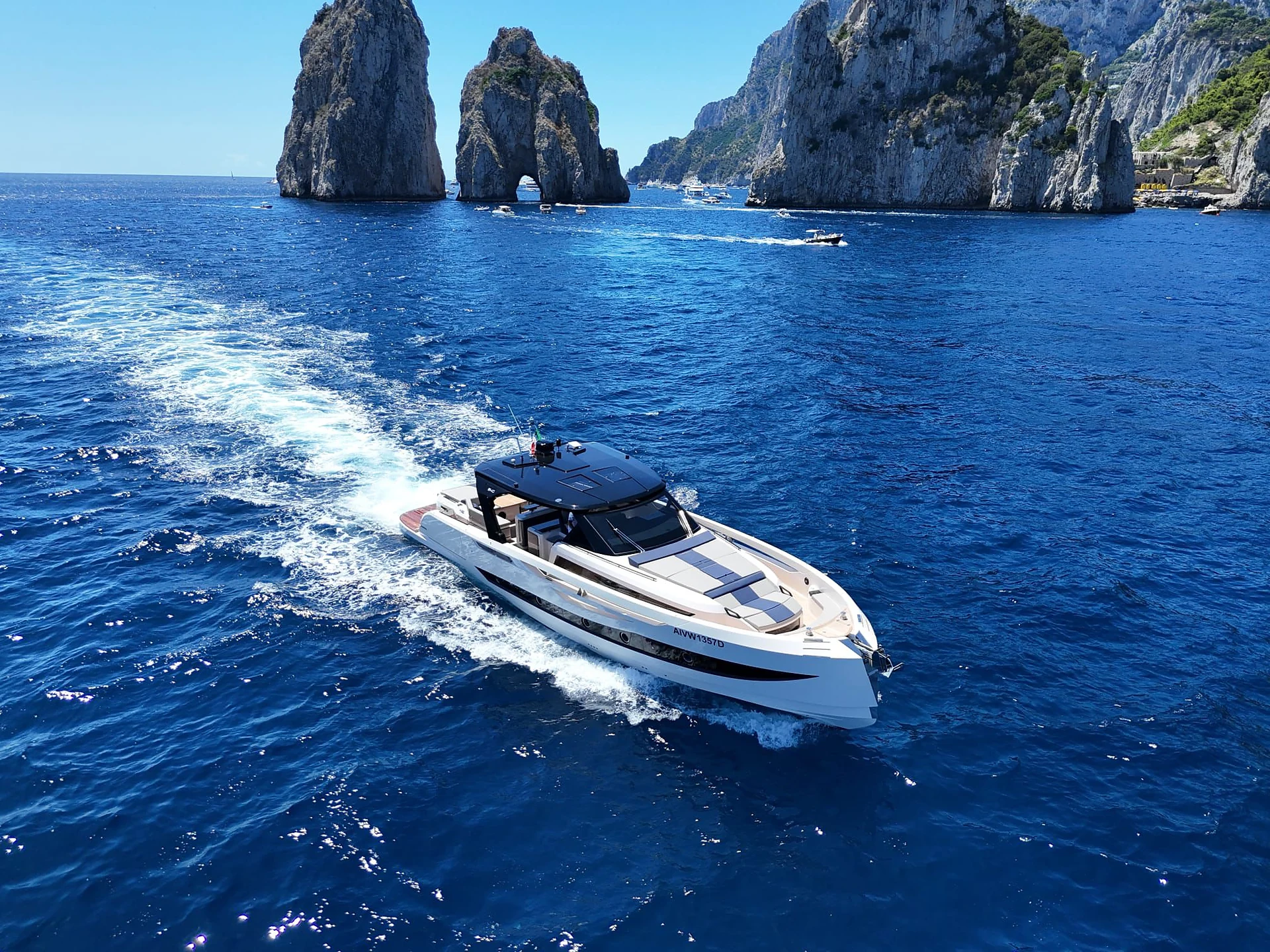 Caiman 54 cruising past the Faraglioni of Capri